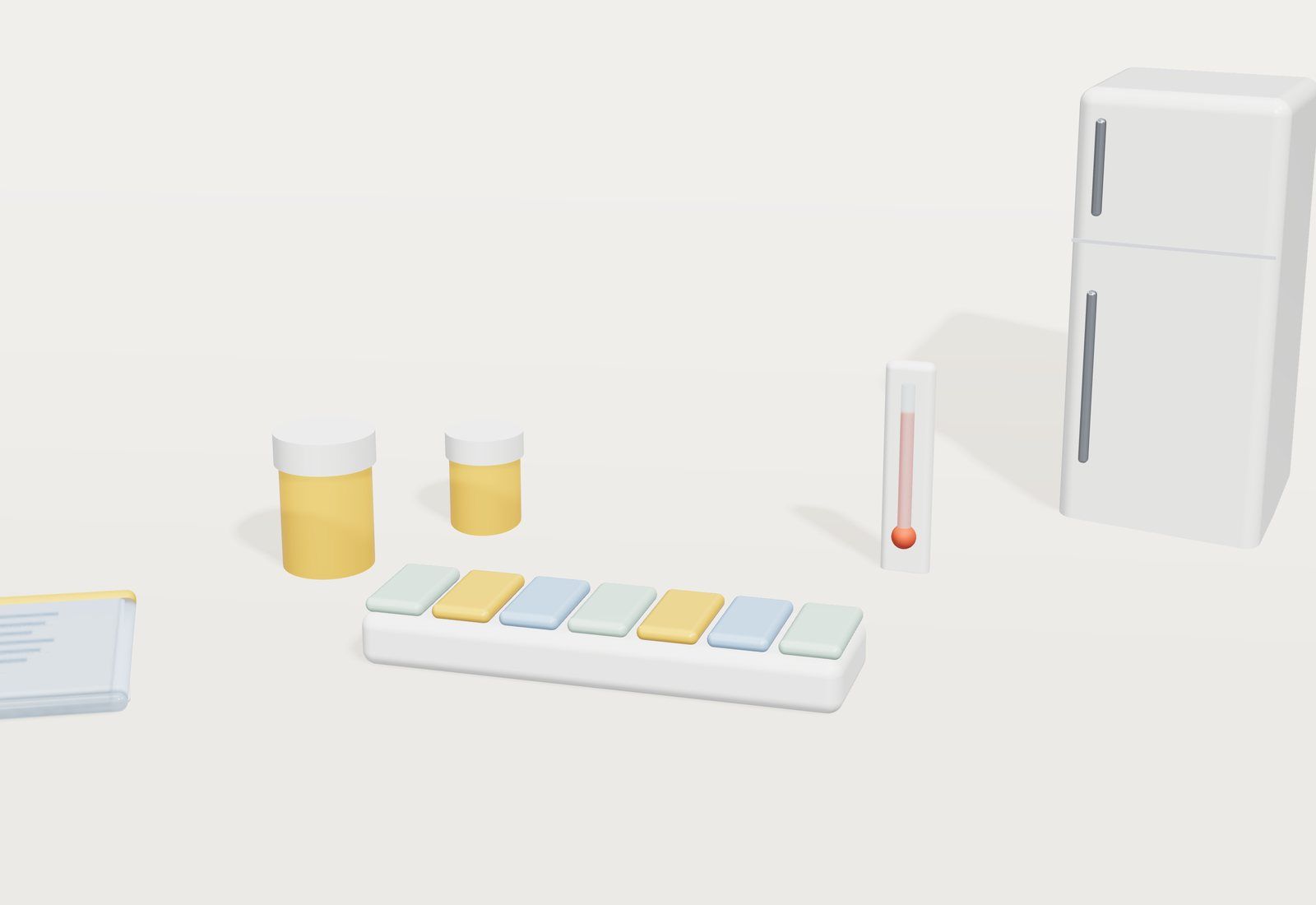 Un pastillero semanal de colores junto a botes de pastillas, un termómetro, una funda de documentos y una pequeña nevera al fondo.